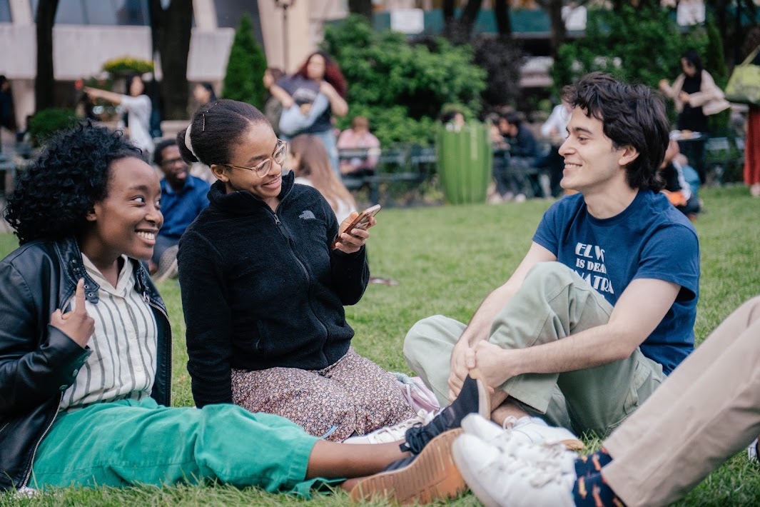 Friends laughing on the grass