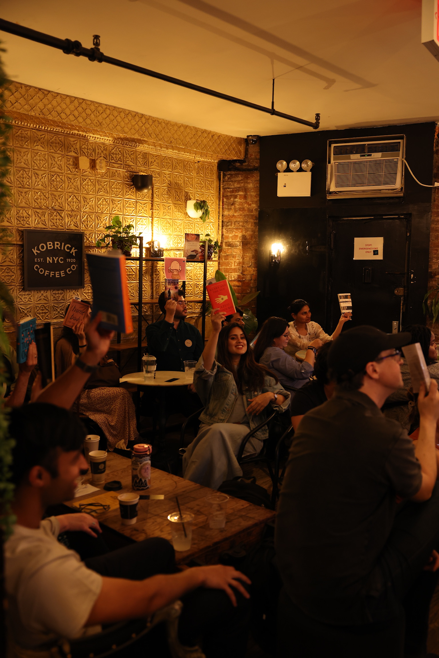 Readers holding up their books at a Reading Rhythms reading party